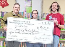 Mark Braun, representing the Gregory Community Foundation, presents a $500.00 grant to Tara Engel, librarian, and Christian Spann to be used at the Gregory Public Library.
