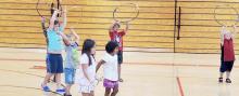 Several children volunteered to join Starr Chief Eagle to try some hoop dancing moves.