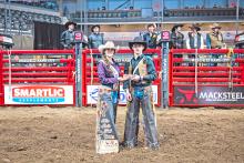 Taos Weborg accepts a buckle for winning the bareback event at 20X at the Black Hills Stock Show earlier this month. (Submitted photo)