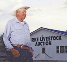 Herris Lambley stands in front of Burke Livestock, the auction barn he owned and operated for 50 years. Lambley passed away in April 2021. (Submitted photo)