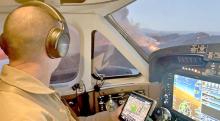 Dave Mundwiler, a lead plane pilot, flies a recent mission in the lead wildfire response plane. In the airspace around wildfires, large airtankers, helicopters, water scoopers all share the same airspace. When unknown drones are spotted all of this activity is grounded due to safety reasons. (Forest Service photo by David Mundwiler)