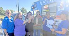 Representing Gregory, l to r; Kathy Svoboda (Buches), Tara Engel (Librarian), JMe Braun (Chamber Director), Trudy Waterman (City Finance Officer), Diane Bachmann (Buches) hold the Peace Torch. The team covered 109 miles on the Monday, July, 13, 2026, running from Colome to Tyndall on Rte. 18, passing the Peace Torch along the way.