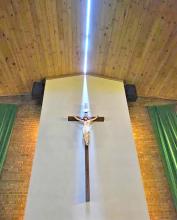 The light shining on the crucifix is sunlight creeping in through the roof at St. Mary’s Catholic Church in Highmore, SD, which was split in half during 130+ MPH winds on Monday, June 29, 2026. (photo by Joseph Mat/Hannah Ekwall TV Facebook page)