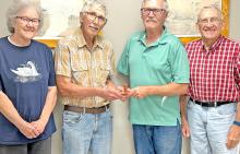 Juanita and Richard Peterson, left, presented the antique items to Jerry Peterson and Clark Gies, right, representing the Gregory County Historical Society.