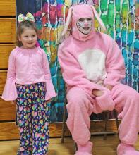 Miah Olson bravely stands near the Easter bunny for a photo.
