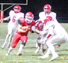 Trey Murray pushes past some Bon Homme defenders on the way to Gregory’s 23-12 win Friday night. The team now sits at #3 heading into Thursday’s playoff game.