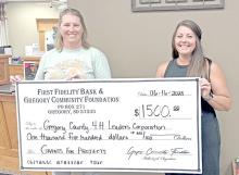 Mollie Andrews, representing Gregory County 4-H leaders, left, received a $1,500 grant to help build livestock facilities for the 4-H program. Aliza Wonnenberg, right, is representing the First Fidelity Bank &amp; Gregory Community Foundation.