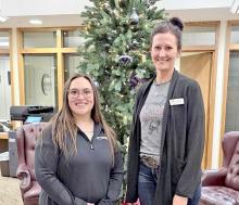 Tamara Atteberry and Tessa Stukel are ready for some presents to put under the Community Christmas tree.