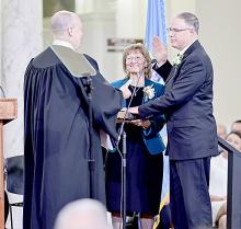 South Dakota Public Utilities Commissioner Chris Nelson takes the oath of office administered by South Dakota Supreme Court Chief Justice Steven R. Jensen, with his wife, Penny, by his side at a ceremony in the State Capitol in Pierre on Jan. 7, 2023. (Photo by Campea Photography)
