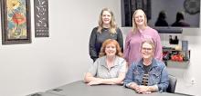 Emily Myrmoe and Lindsey McCarthy, standing, and Karla Zick and Liz VanOverschelde are shown here in the conference room which is also set up for video counseling appointments.