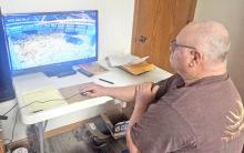 Steve Easton checks on his pregnant cows using a camera system in rural Hanson County, S.D., on March 4, 2025. (Photo: Megan Luther/ South Dakota News Watch)