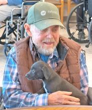 Kelly Kreinbuhl, formally of Iona, SD, with the puppy who wanted to snuggle.