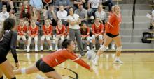 Senior Anna Dargatz goes low for a bump for the Gregory Spikers as Gracie Kenzy watches.