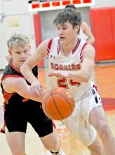 An Avon defender tries for the ball as Gregory’s Nick Kenzy makes his way down the court in a Gorilla win last Thursday at home.
