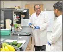 Srinivas Janaswamy, shown in his South Dakota State University lab holding biodegradable film made from agricultural byproducts.