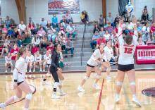 Dani VanDerWerff, #2, is ready to send the ball over the net as Ella Sperl, #12, sets it in Gregory’s momentous win over Wagner, breaking an 18-year streak. (Photo by Calli Jo Photography)