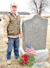Gregory County Veterans Services Officer Dale Reber is shown here after placing a wreath at the grave of World War I Veteran Alfred Hutchison.