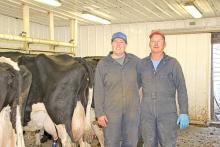 Verlyn and Dana Jons stand in their stanchion barn April 22 on their dairy near St. Charles, South Dakota. They are the last dairy in Gregory County. (Photo by MLPhotography)