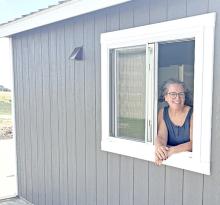 Kristi Drey, owner of the Train Station Ice Cream Shop, shows off the newly installed drive-through window.