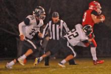 Owen Hansen, #3, tries to slip out of the grasp of a Burke defender in Gregory’s 34-6 win to claim their position into the first round of playoffs.