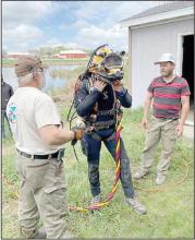The diver’s helmet, outfitted with a camera and microphone weighs around 40 pounds on land, but most of that weight is negated in the water. An umbilical cord supplies oxygen and communication lines.