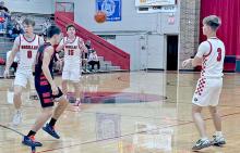 Lincoln Juracek, #3, passes the ball to Jacob Klein, #15, who scored 7 points in the first quarter against Lyman. (Photo by Brenlee Braun)