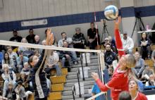 Raesha Beck tips the ball over the net in Gregory’s match against Burke in the second round of post-season play.