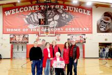 The new “Welcome to the Jungle” banner was purchased as a memorial to Stanley and Elma Chocholousek, perennial fans of the Gregory School District. Pictured in front, l to r: Roger and Julie Greer, Elma Chocholousek, Roxie and Dave Chocholousek, and Dennis and Linda Purvis in the back.