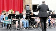 Band Instructor Jared Opp conducts the fifth grade band as they kick off the elementary spring concert with “The World’s Greatest Show,” a three-part arrangement by William Owens.