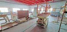 The weight room at the new wellness center at the school features lots of windows and a wall of mirror to check form when lifting weights.