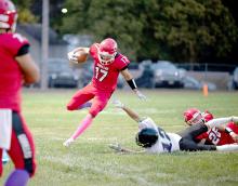 Luke Stukel, #17, takes advantage of a clearance created by Paul Sinclair, #25, to gain some yardage in Friday night’s Homecoming game against Kimball/White Lake. (Photo by Calli Jo Photography)
