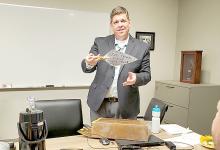 The first item Hospital and Nursing Home Administrator Tony Timanus removed from the sealed copper box found at the nursing home was a trowel. It had been used by Mrs. Martha Faust to lay the cornerstone.