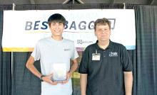 Mahlon Bruguier, l, representing Cahoy’s General Store in Lake Andes, was the top grocery bagger at the South Dakota Best Bagger competition at the South Dakota State Fair. Justin Ekroth, r, of Buche Foods in Gregory placed second. (photo from South Dakota Retailers Association)