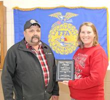 Rosebud Farmers Union General Manager Clayton Whitney presented a plaque to Mollie Andrews in appreciation for all she does as the Gregory County FFA Advisor to promote agriculture to her students.
