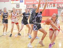 Renae Prokopec eyes the basket through the arms of a Titan defender. (Photo by Charissa Ring)