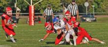 Three Gorilla defenders stop a Parkston ball carrier.