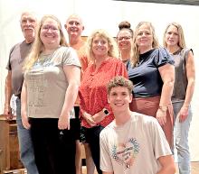 Cast members include back row, l to r: Wes Schell, Dr. Joe Hull, Tayler Spraw, and Ann Fogel. Middle row, l to r: Caitlin Kurtz, Jana Winters, and Ronda Graber. Front row: George Timanus.