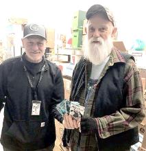 Rod Dobesh of Greenlight Dispensary donated five $100 gift cards to local residents in need recently. Ed Nebola of Wear N Wares helped identify the recipients.