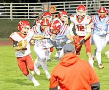 Lincoln Juracek fends off a Bon Homme defender in the first round of post-season playoffs Friday night. (Photo by Sara Anderson)