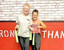Proving that age is just a number, 80-year-old Genene Sand puts her strength on display after breaking an exercise band during her workout at Get Fit With Jenny. A client for the past year, Sand works out twice a week and credits her commitment to fitness with significantly reducing her arthritis pain and improving her health.