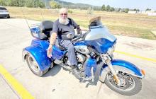 Bob Walker, 83, of New York, rode his three-wheeled Harley-Davidson to the Sturgis Motorcycle Rally this year and stopped briefly at a discount store in Summerset, S.D. on Aug. 5, 2026. (Photo: Bart Pfankuch / South Dakota News Watch)