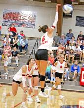 Regan Graesser, #5, attacks the ball against Wessington Springs last Tuesday at home. She had 21 kills, 2 aces, 8 set assists, and 17 digs against the Lady Spartans. (Photo by Kristy Ring)