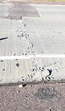 Shown above is one of the two spots on Hwy. 18 where the concrete road heaved up from extreme heat and crumbled, leaving behind rubble and a sizable gap that could create a hazard for drivers.