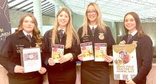 The Gregory County FFA Ag Communications team of Ava Kerner, Ella Sperl, Aubree Miller, and Avery Zeisler, l to r, are shown here with the coloring books, poster, and portfolio they included in their communications plan for “Drive Your Tractor to School” Day. They won the state competition with their presentation and will move on to the national competition next fall in Indianapolis.