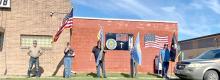 The riders were greeted by a patriotic flag line as they came into town.