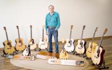 Joe Tyburec’s granddaughter talked him into doing a photo shoot recently with all of the guitars, mandolins, and steel guitars he still has that he had built over the years. (Photo by Bailey Veskrna)