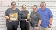 Left to right; Amanda Konechne, Calli Bordeaux, Trisha Cahoy, and Dan Cahoy of Cahoy’s Kitchen in Burke, hold the trophy for winning Gregory Countys first burger Battle.