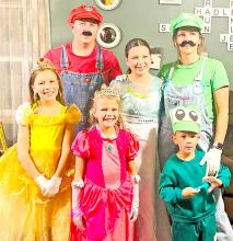 The Mark and Jenny Braun family always show up to the Carlock Masquerade Dance dressed in a family theme. This year is was Mario Bros.