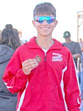 Junior Luke Barreto brought home a medal for his 25th place finish at the state cross country meet. (Photo by Jeff Determan)