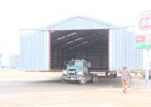 Moving a building is big news. On Monday morning, Klein’s House Moving crew moved a large metal building from the far east side of Cenex’s property to behind the fuel station. This move had been planned for some time as part of the elevator closing. The building will be used for storage in its new location. (Photo by Shelby Jones)